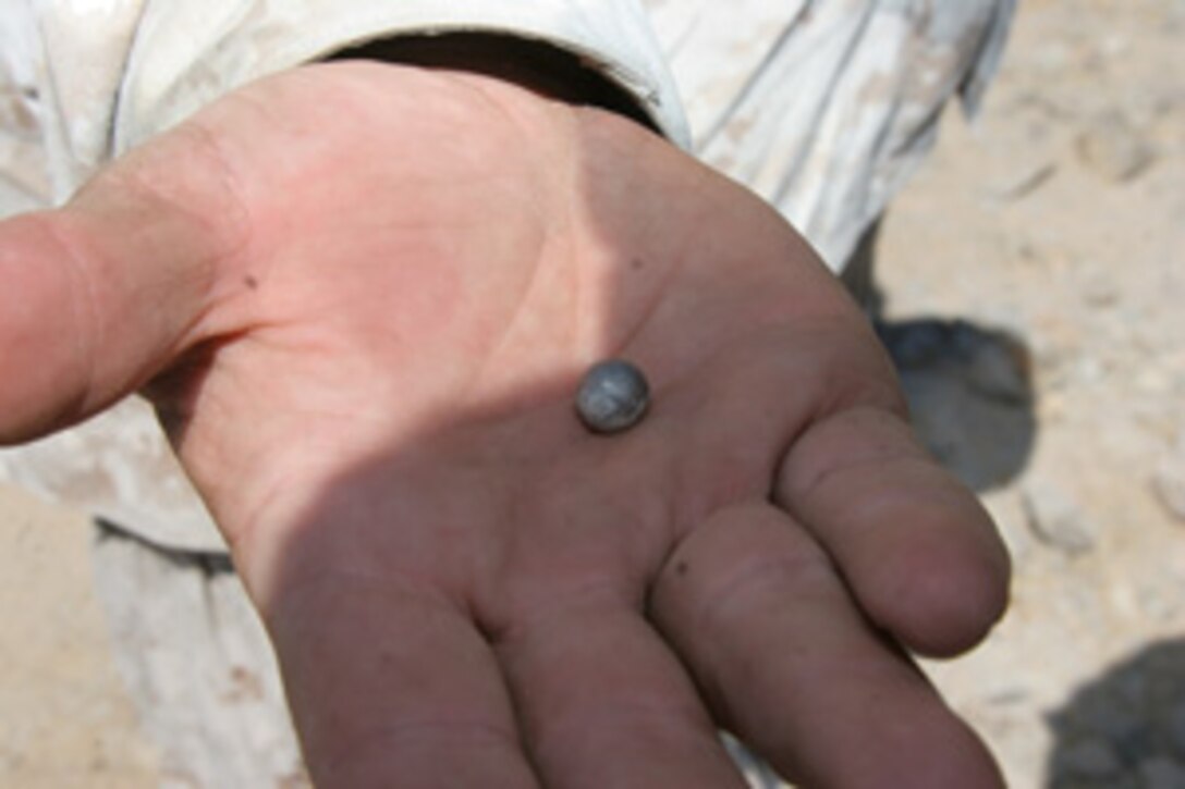 Staff Sgt. Timothy L. Duvall holds in his hand a three-eights of an inch, tungsten ball that dispersed from an M1028 120 mm Canister Round.  The round was shot from an M1A1 main battle tank with Delta Company, 1st Tank Battalion at Combat Center?s Range 500 Sept. 19.