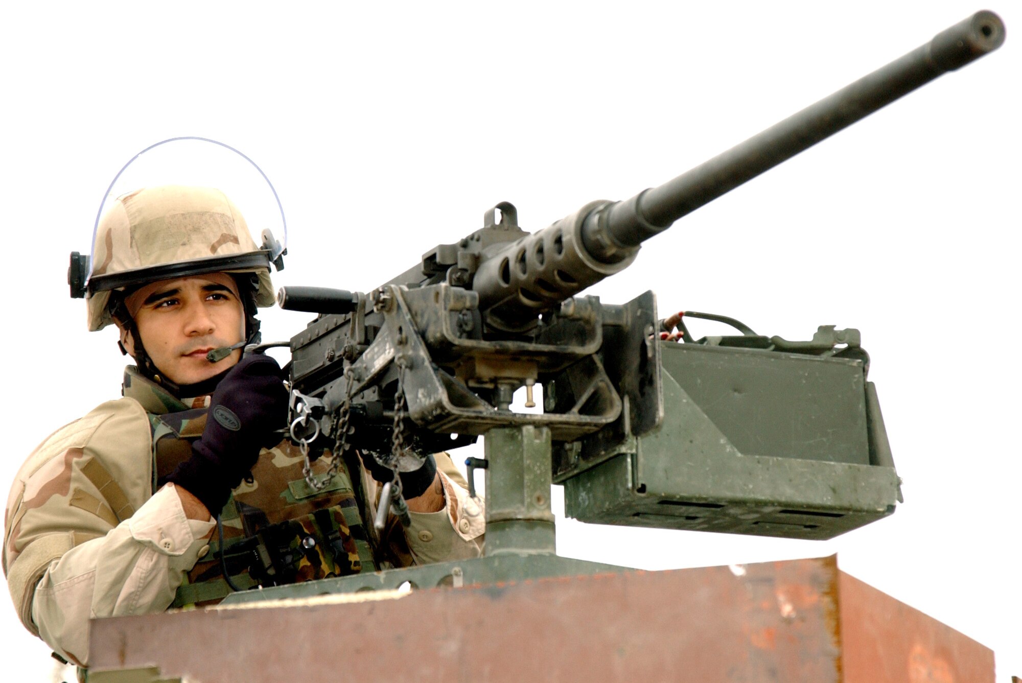 TIKRIT, Iraq -- Senior Airman Ronnie Rodriguez stands ready at a 50 caliber machine gun before a convoy security mission in Iraq.  He is assigned to Detachment 1058 of the 732nd Expeditionary Logistics Readiness Squadron.  (U.S. Air Force photo by Master Sgt. David Reagan)