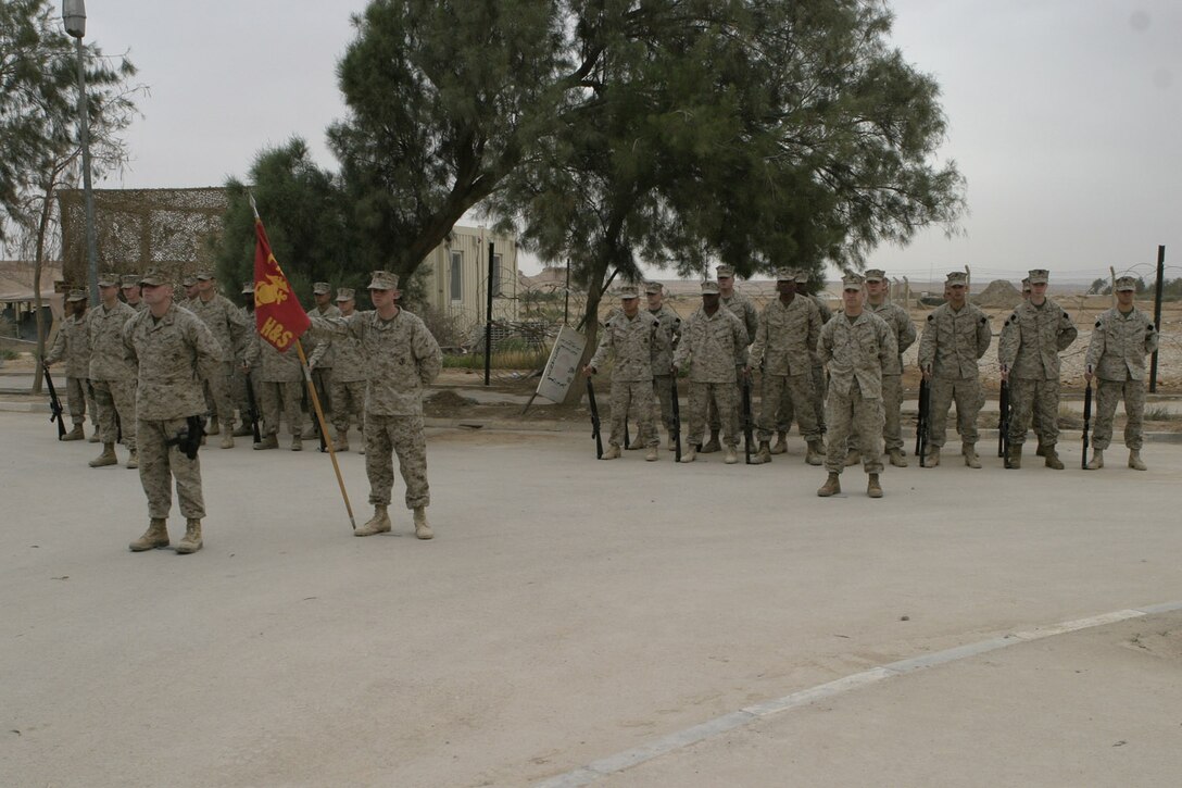 AL ASAD, Iraq -- Marines with Headquarters and Service Company, Provisional Security Battalion, stand in formation during the change of command ceremony between 1st Lt. Michael K. Mishoe Jr. and Capt. Tom Chhabra on April 20.  Mishoe, from Corning, Calif., comes to the unit from Bravo Company, Provisional Security Battalion.  Chhabra, outgoing commanding officer and West Windsor, N.J, native, assumed command of the company in February 2004.