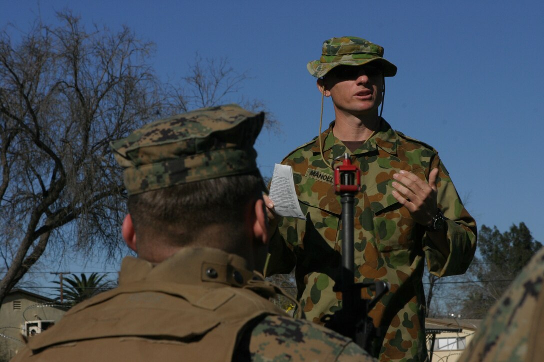 050119-M-4224F-004 MARCH AFB MORENO VALLEY, Calif.- Austrailian Army Capt. Paul Manoel, an exchange officer from Townsville, Austraila explains to Marines with 3rd Battalion, 2d Marine Regiment from Camp Lejeune, N.C., what it takes to run a successful entry control point during security and stabilizations operations training Jan. 19. The training was the last opportunity for the Marines of the battalion to prepare for deployment to Iraq. Offical U.S. Marine Corps photo by Lance Cpl. Lucian Friel (RELEASED)