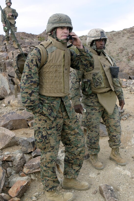 MARINE CORPS AIR-GROUND COMBAT CENTER TWENTYNINE PALMS, Calif. - Cpl. Gabriel W. Kintzley, Weapons Platoon, Company A, 1st Battalion, 6th Marine Regiment machine gunner, talks on the radio during a combined arms assault his unit conducted aboard Range 410A here.  Kintzley and fellow machine gunners' roles are to provide suppressive fire for rifle platoons as they close in on their target objective.