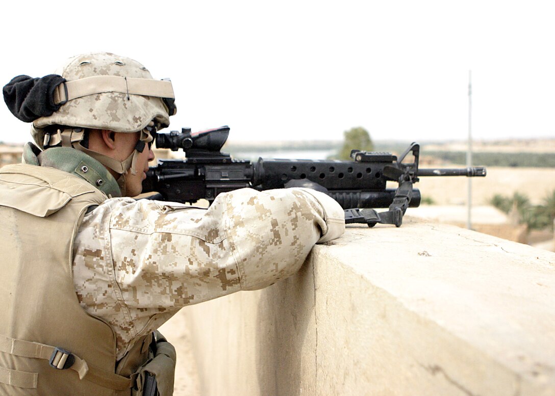 Haqlaniya, Al Anbar, Iraq (April 20, 2005)-- A Marine with 3/25 sights in on a potential insurgent after numerous attacks on other units around the city.(Official USMC Photo by Corporal Ken Melton)