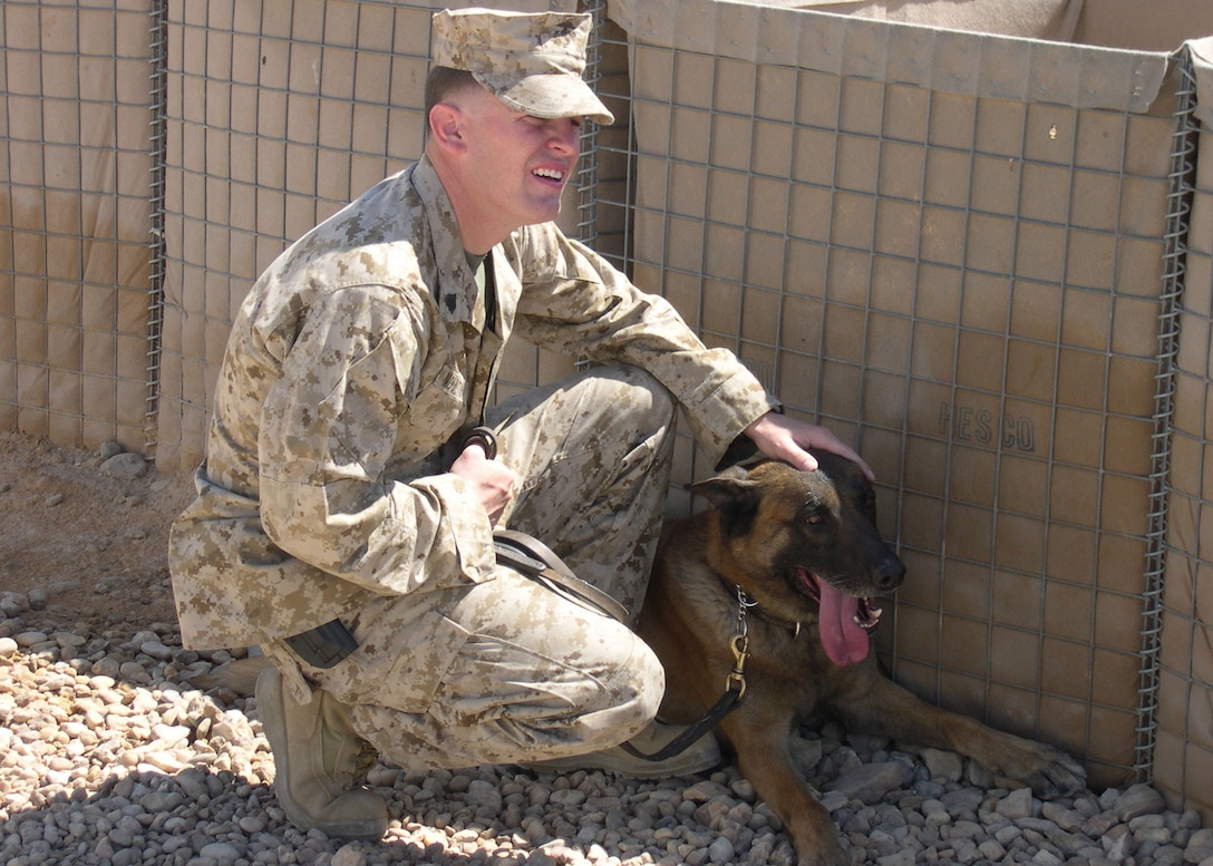 Camp Ripper, Al Anbar, Iraq (April 7, 2005)-- Sgt. Christoper S. Moulton, 23 of Augusta, Ga., native, and Fido, a 7-year-old Belgian Malinois, both members of the K-9 security force take a break from a routitne search.(Official USMC Photo by Corporal Ken Melton)