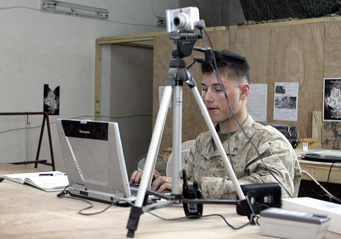FALLUJAH, Iraq - Lance Cpl. Tyler Duffin, a Marine with 1st Battalion, 6th Marine Regiment who helps man northern Fallujah's Entry Control Point-2, inputs a resident's data into a city-wide database containing names and vital information about Fallujah's residents.  The 20-year-old Michigan City, Ind. native works alongside Iraqi Security Forces to prevent weapons, explosives and insurgents from entering the city.
