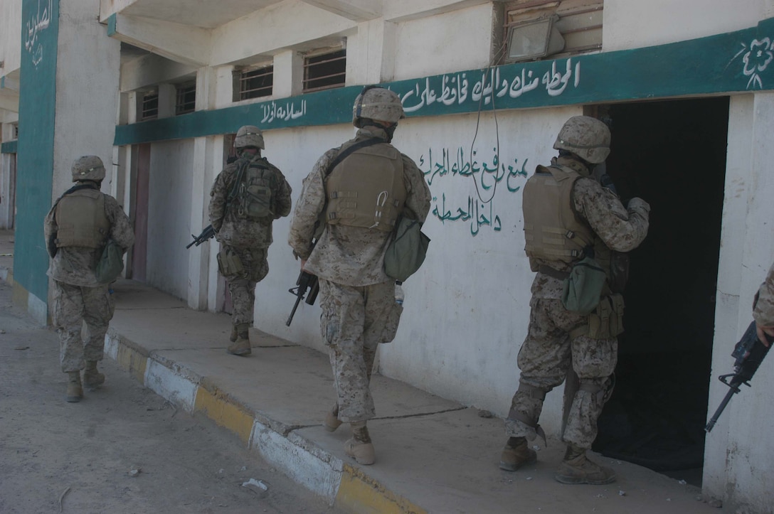 AR RAMADI Iraq (June 14, 2005) - Marines with 1st Section, 1st Mobile Assault Platoon, Company W, 1st Battalion, 5th Marine Regiment, search rooms of a building here during a mission. Insurgents attacked the Marines with an improvised explosive device during a presence patrol they executed in the southern portion of the city. No one was hurt and no vehicles were damaged. Photo by: Cpl. Tom Sloan
