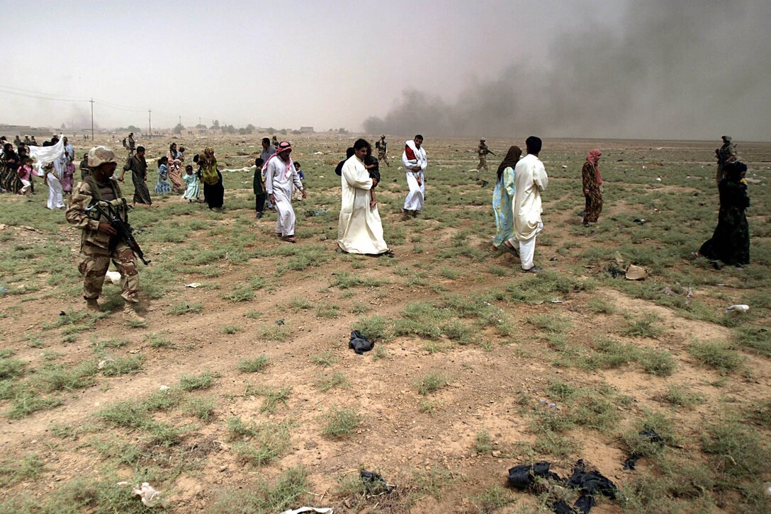 Karabilah, Al Anbar, Iraq (June 20, 2005)-- Marines with 2nd platoon,  Company "L", 3rd Battalion, 25th Marine Regiment and members of the 7th Iraqi Security Force escort families out of immediate danger areas in Karabilah during Operation Spear. (Official USMC Photo by Corporal Ken Melton)
