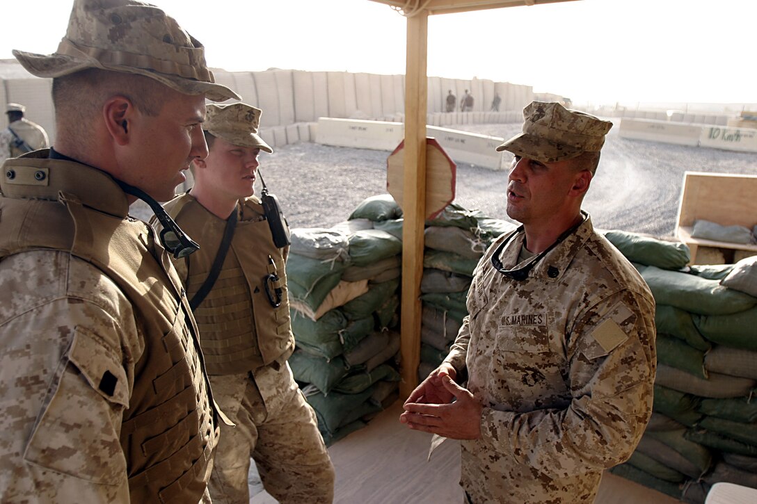 Camp Ripper, Al Asad, Iraq (August 14, 2005)--LeHigh Acres, Fla., native, Staff Sgt. Charles E. Sexton, Regimental Combat Team-2 guard chief talks to his Marines Cpl. Joseph L. Scappace, 24 of Greenville, Mass., and Lance Cpl. David G. Weimortz, 28 of Columbia, S.C., native, during their evening change over of guard duties.(Official USMC Photo by Lance Cpl. Ken Melton)