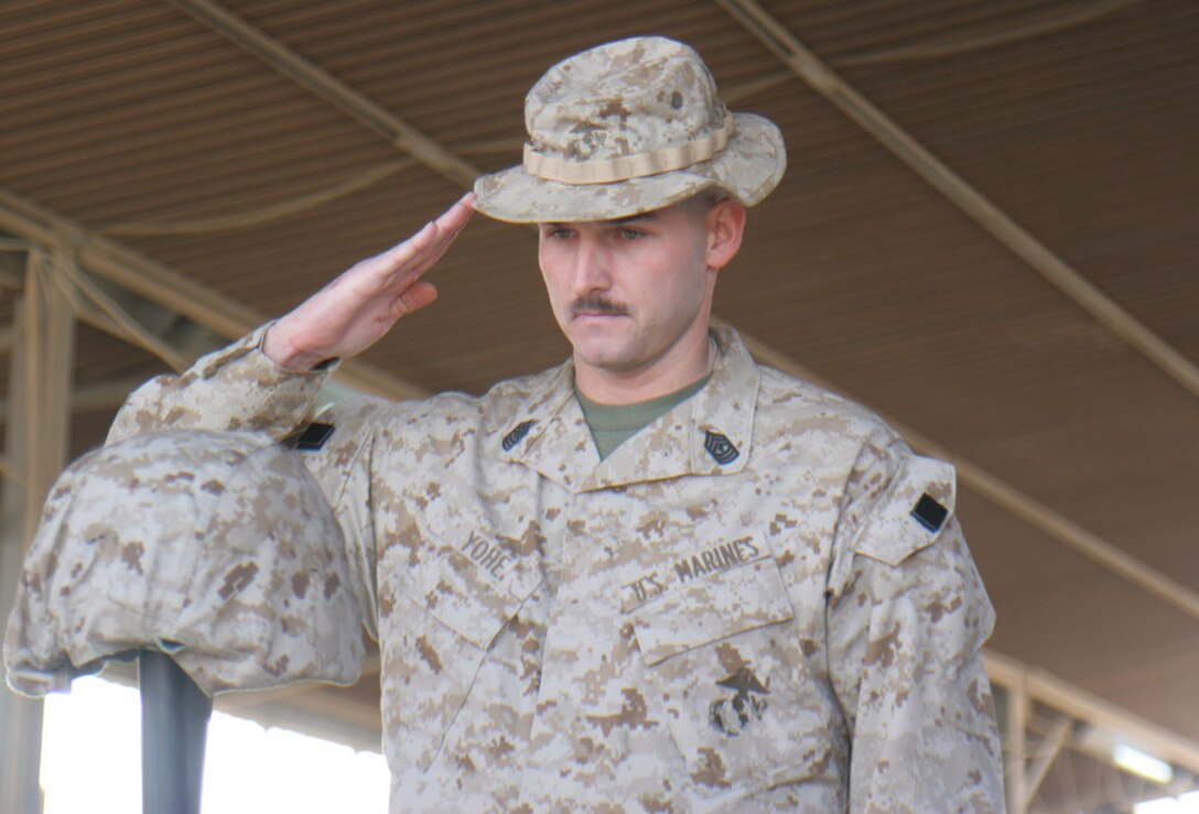 051020-M-2607O-015 -First Sgt. Craig T. Yohe salutes his fallen Marine Shayne M. Cabino on Oct. 20 during the memorial service aboard Camp Fallujah.