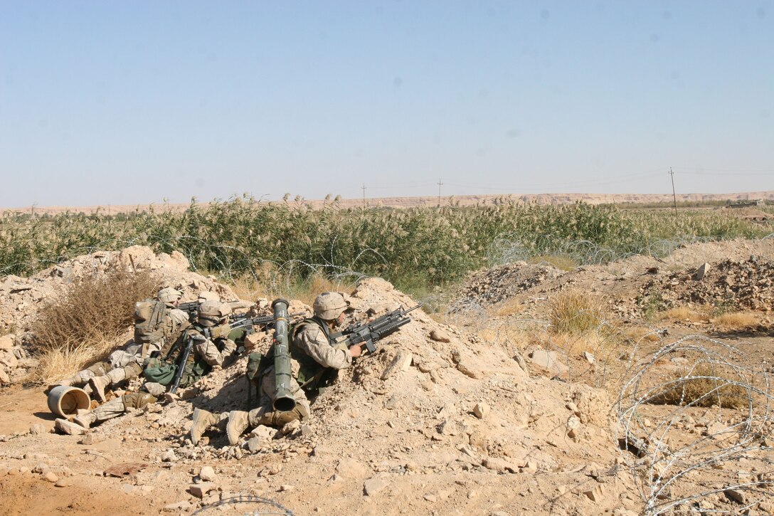 Marines from Company L, 3rd Battalion, 6th Marine Regiment, provide security while members of their platoon search and clear a building during Operation Steel Curtain, Nov. 5, in Husayba, Iraq.