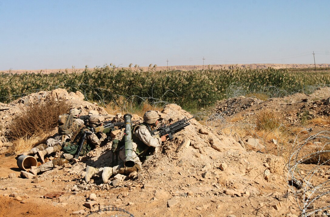 Marines from Company L, 3rd Battalion, 6th Marine Regiment, provide security while members of their platoon search and clear a building during Operation Steel Curtain, Nov. 5, in Husayba, Iraq.