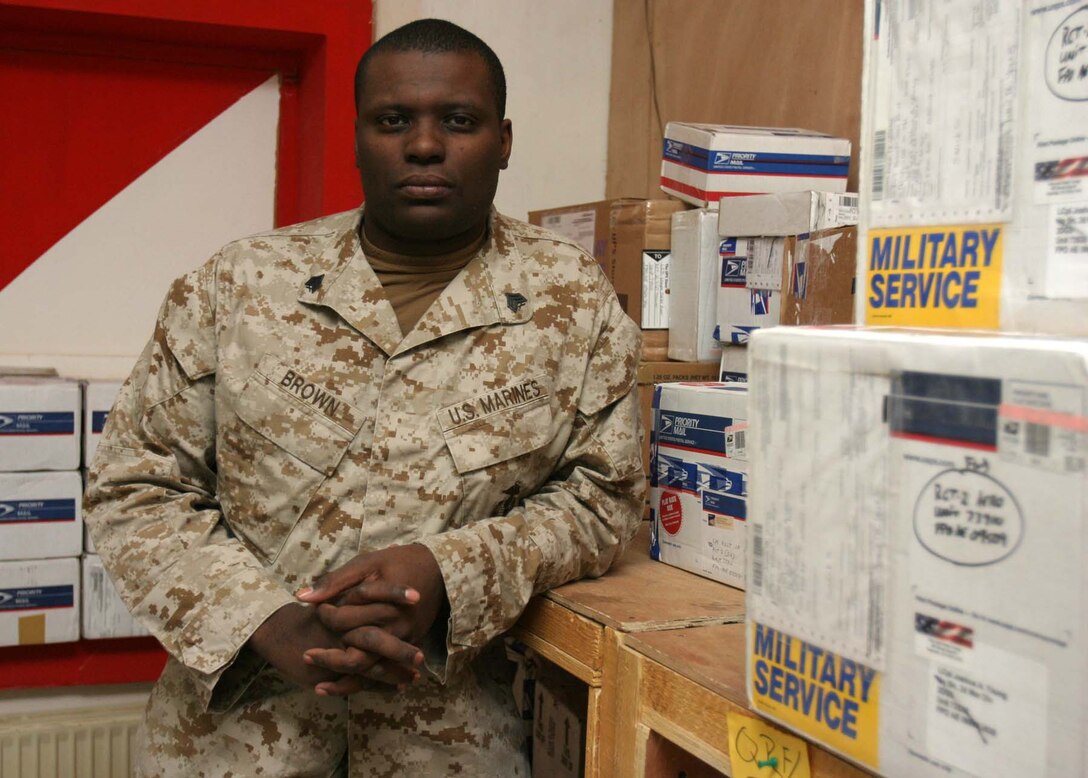 CAMP RIPPER, Iraq (Nov. 18, 2005)  - Denver native Sgt. Dorian D. Brown, a mail and administrative non-commissioned officer with Regimental Combat Team-2, keeps morale high with Marines here by handing out mail on a daily basis. Brown, a recent meritoriously promoted sergeant, has been supporting the Marines as they participate in Operation Iraqi Freedom. (Official Marine Corps photo by Cpl. Adam C. Schnell)