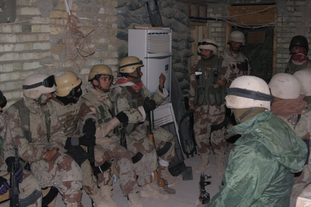 011120-M-2607O-003 - The Iraqi Army Solders are being briefed by their lieutenant before the raid on an expected insurgent's house in the city of Al Karmah, Iraq, on Nov 20.
