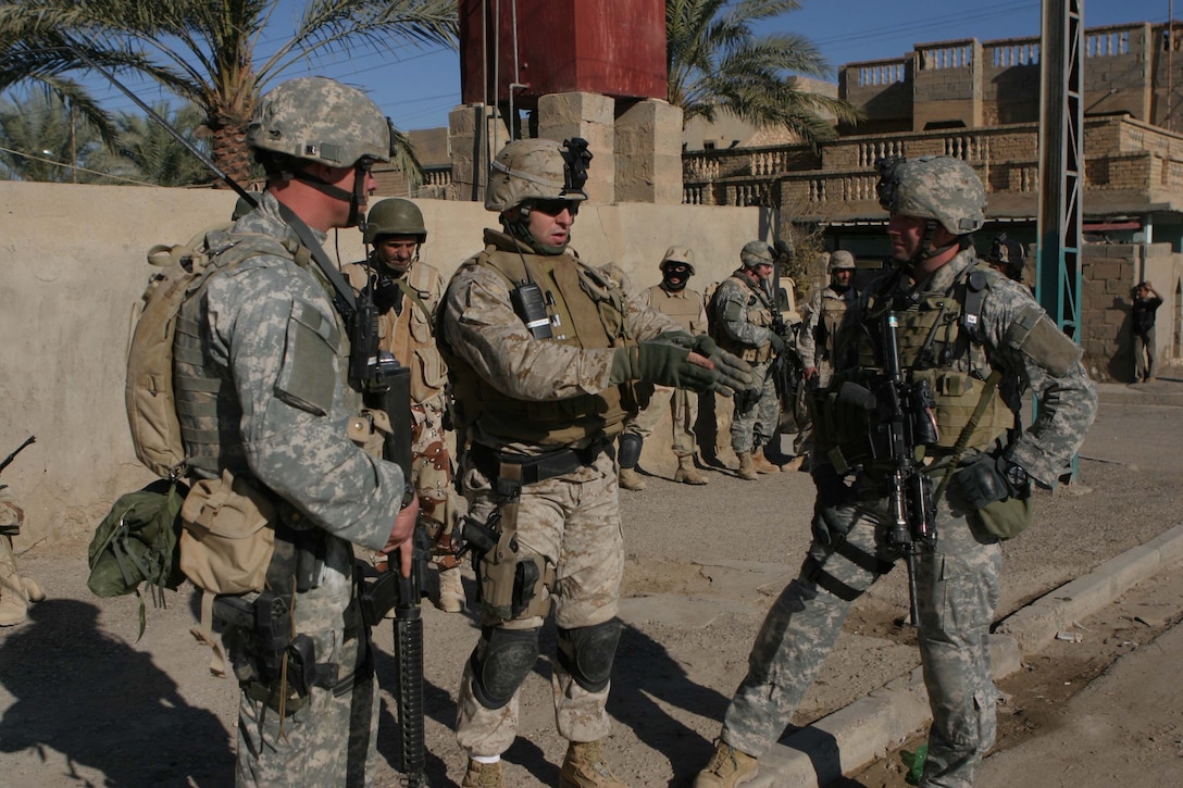 CAMP DEFENDER, RAMADI, Iraq - Major John Armellino the Military Transition Team battalion commander for 1st Battalion, 1st Brigade of the 7th Iraqi Army Division discusses the effectiveness of his Iraqi Battalion with fellow U.S. military advisors during Operation Lions here. Operation Lions was a major milestone for 1-1-7 who operated independent from U.S. military support. Official U.S. Marine Corps photo by Sgt. Ryan S. Scranton