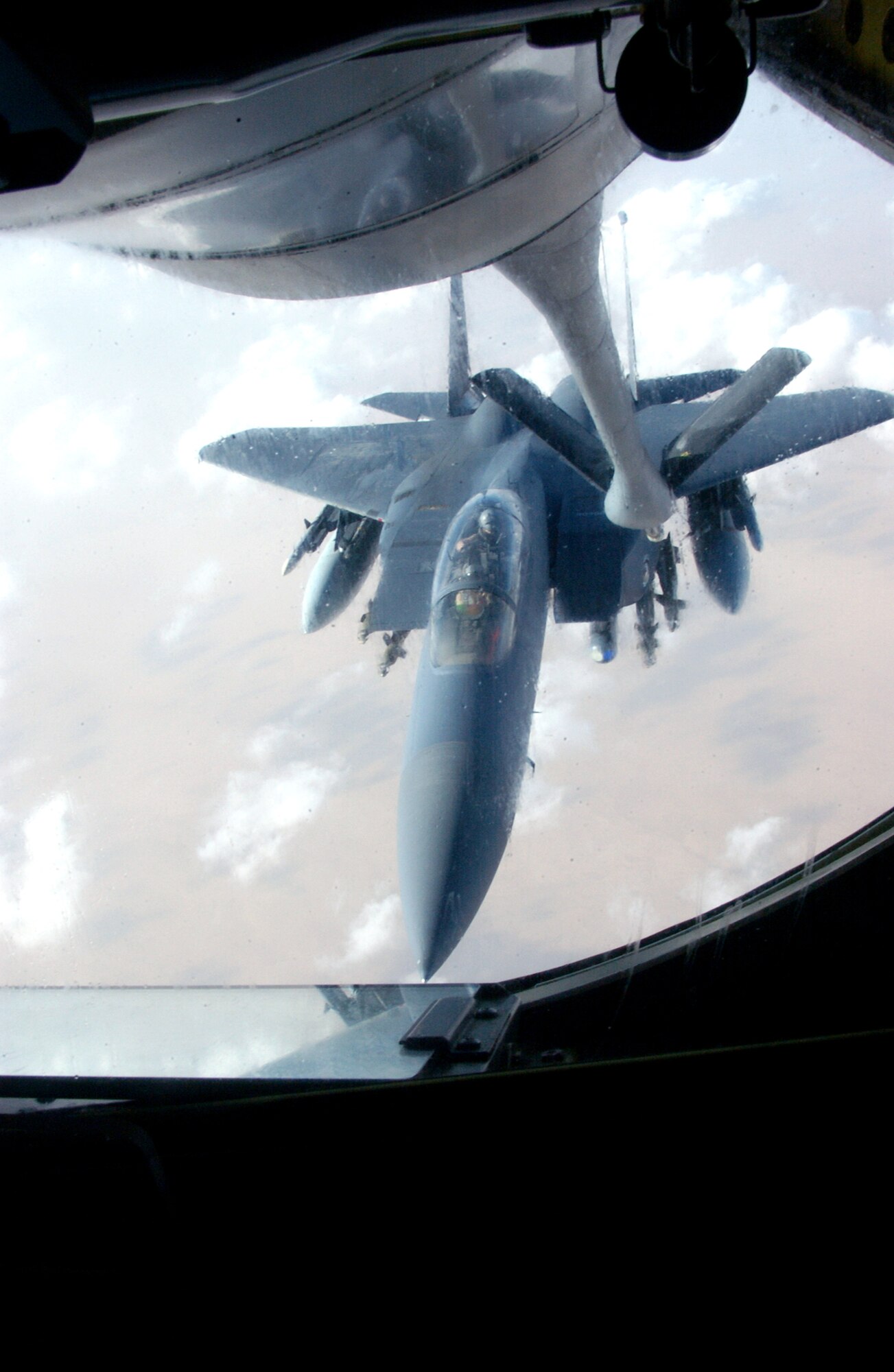 OVER IRAQ -- An F-15 Eagle lines up to receive fuel from a KC-135 Stratotanker during a combat mission supporting Operation Iraqi Freedom.  (U.S. Air Force photo by Senior Master Sgt. Mark Moss)