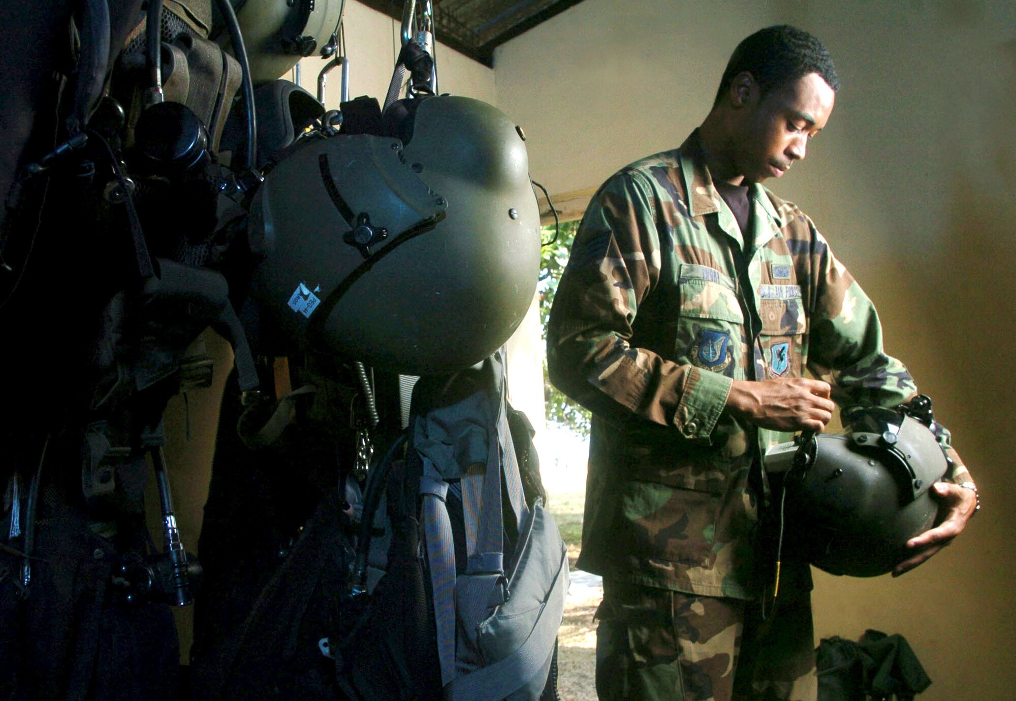 COLOMBO, Sri Lanka -- Staff Sgt. Rob Ivory inspects flight gear of HH-60G Pave Hawk helicopter crews supporting Operation Unified Assistance.  Sergeant Ivory, a life support technician, and others from the 33rd Rescue Squadron at Kadena Air Base, Japan, are helping move relief supplies to tsunami victims.  (U.S. Air Force photo by Master Sgt. Val Gempis)