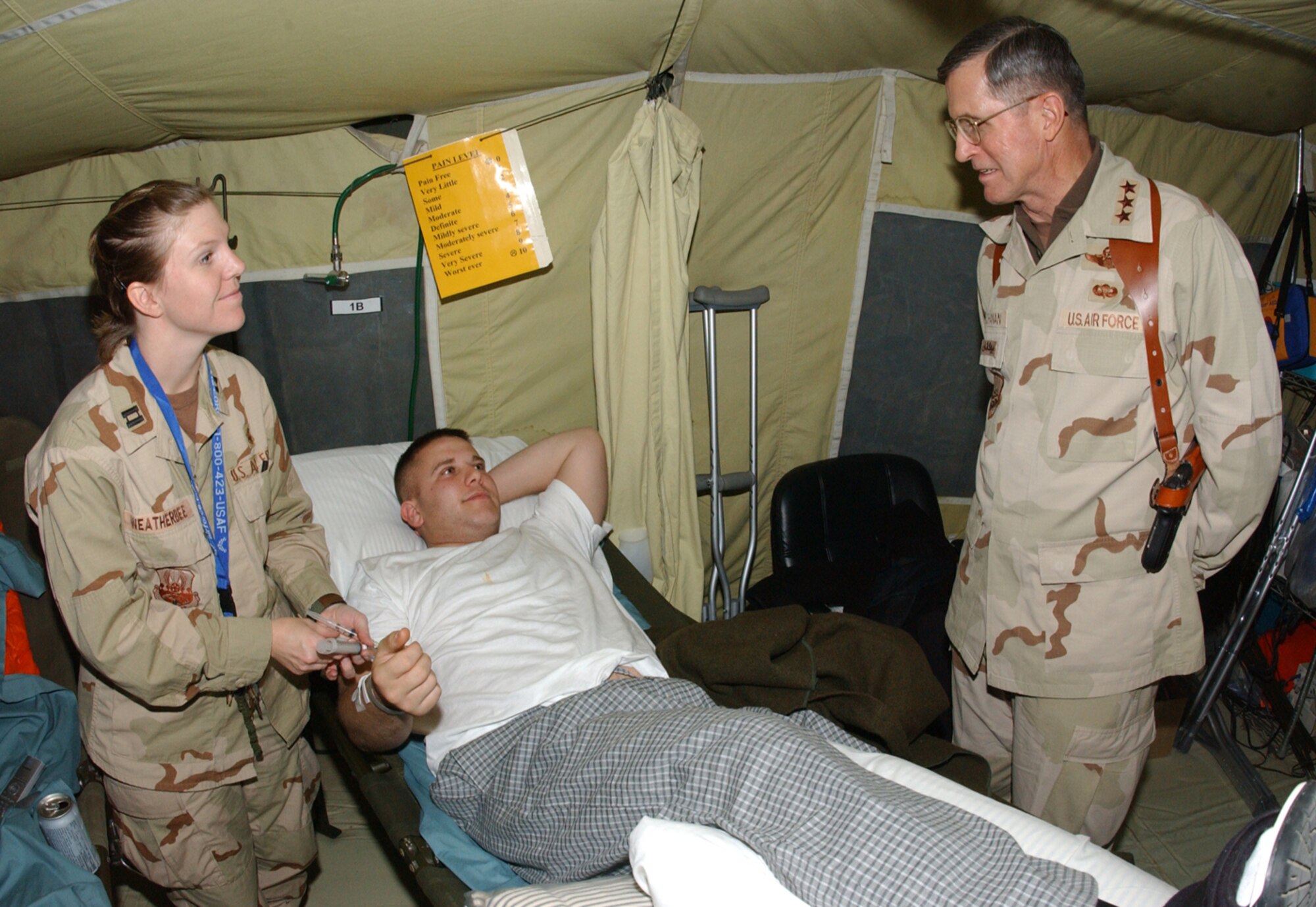BALAD AIR BASE, Iraq -- Lt. Gen. Walter E. Buchanan III talks with Capt. Tamra Weatherbee and Army Pfc. Matt Baugh at the contingency aeromedical staging facility here Jan. 16.  The general commands 9th Air Force and U.S. Central Command Air Forces and he stopped by the facility to visit staff and patients during a short visit to Balad.  Captain Weatherbee is a staff nurse deployed from the 859th Medical Operations Squadron at Lackland Air Force Base, Texas.  Private Baugh is a member of the Army's 15th Infantry Division deployed from Fort Lewis, Wash.  (U.S. Air Force photo by Tech. Sgt. Marc Barnes)