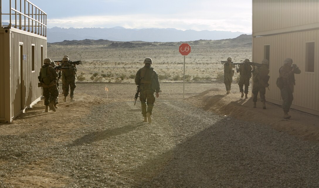 MARINE CORPS AIR-GROUND COMBAT CENTER TWENTYNINE PALMS, Calif. - After a long day of clearing houses and patrolling the city streets, warriors from Company A, 1st Battalion, 6th Marine Regiment make a final sweep through the Military Operations in Urban Terrain facility here.  The unit participated in a Revised Combined Arms Exercise here to prepare for an upcoming deployment to Iraq in March.