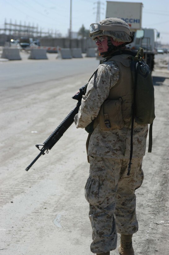 AR RAMADI, Iraq (March 21, 2005) - Nineteen-year-old Pfc. Jamie L Roberts, rifleman, Quick Reaction Force, Company C, 1st Battalion, 5th Marine Regiment, of Kennett Mo.,, patrols the road where the entry control point is set up on the edge of the South Bridge here. Marines with Company C, 1st Battalion, 5th Marine Regiment, and ISF Commandos conduct random vehicle searches at the ECP, which is located between Marine Camps Snake Pit and Hurricane Point, around the clock in an effort to prevent explosives and weapons from being brought into the city. The Marines are currently the over watch for the ISF Commandos as they conduct the searches. Between 500 and 1000 vehicles enter the city through the ECP each day. Photo by Cpl. Tom Sloan
