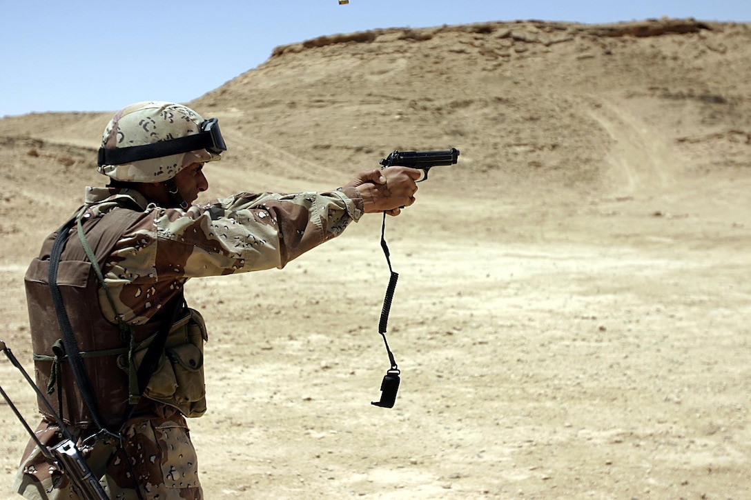Camp Ripper,Al Asad, Iraq (May 21, 2005) -  A member of the reconnaissance company of the 7th Iraqi Security Battalion practices shooting the M-9 during his freetime in between training sessions.  (Official USMC photo by Cpl. Ken Melton)