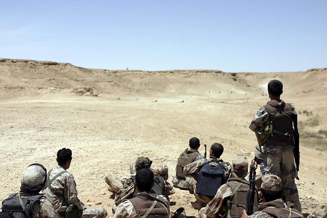 Al Asad, Iraq (May 21, 2005) -  Soldiers of the reconnaissance company of the 7th Iraqi Security Battalion watch as Marines demonstrate the methods they will apply during the next training session.  (Official USMC photo by Cpl. Ken Melton)