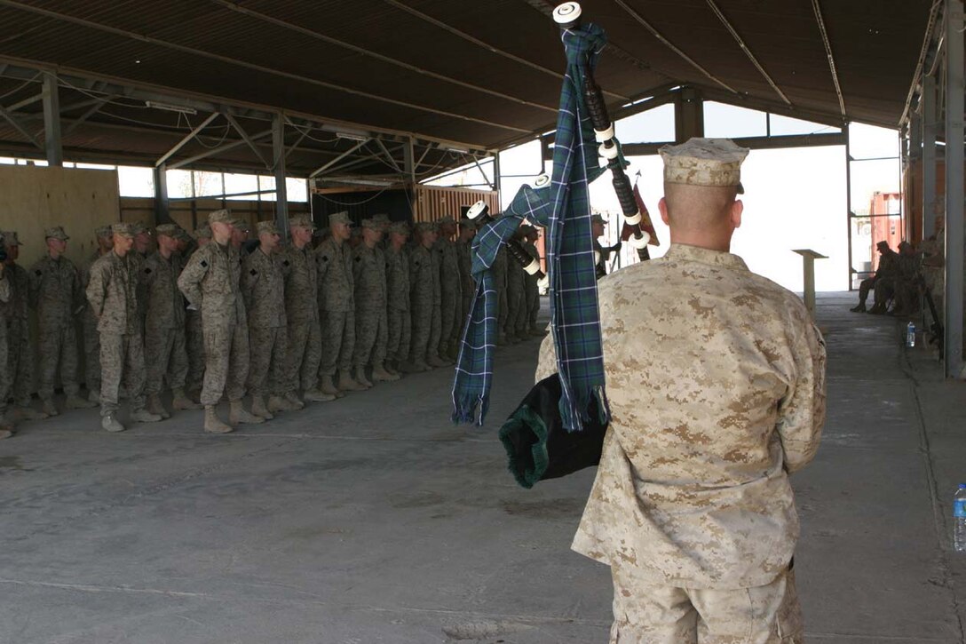CAMP FALLUJAH, IRAQ -- Lance Cpl. Matthew Bucceri, India Company, 3rd Battalion, 8th Marine Regiment, plays Amazing Grace on his bagpipes during a memorial service for his fallen brother-in-arms May 21.  Lance Cpl. John T. Schmidt was honored by his fellow Marines who spoke of memories they had over the short time they had with him.  Official U.S. Marine Corps photo by Lance Cpl. Athanasios L. Genos