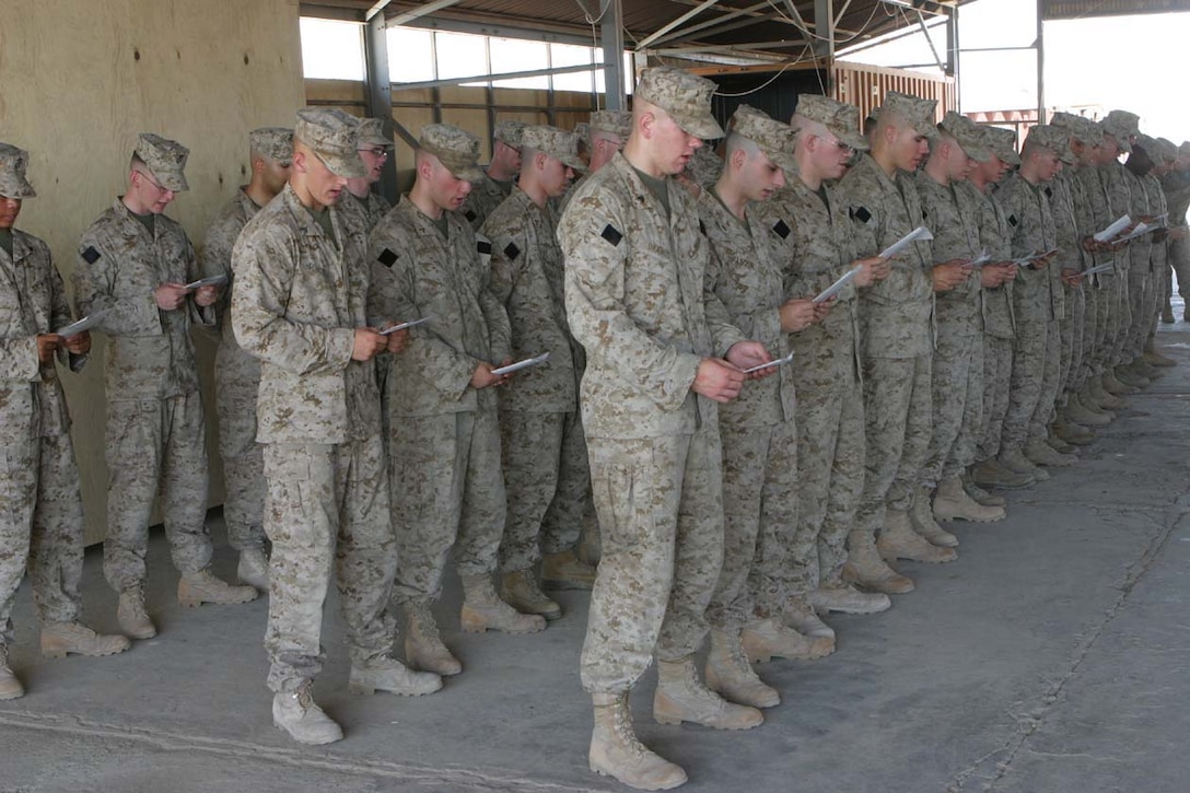 CAMP FALLUJAH, IRAQ -- Marines from India Company, 3rd Battalion, 8th Marine Regiment read aloud Psalm 23 in remembrance of their fallen brother-in-arms, Lance Cpl. John T. Schmidt at a memorial service held May 21.  The Marines honored their fallen brother on Armed Services Day, and it is forever a day that will be remember in their minds.  Official U.S. Marine Corps photo by Lance Cpl. Athanasios L. Genos