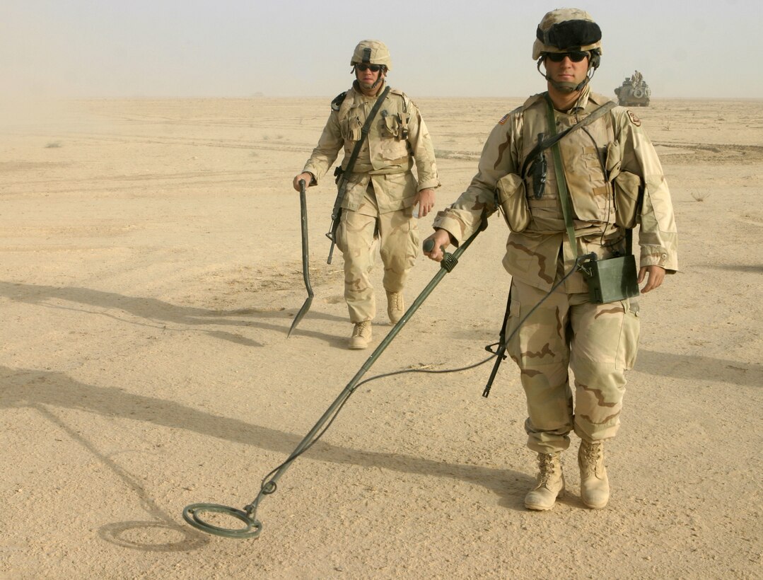 THAR THAR REGION, Iraq - U.S. Army engineers use metal detectors to search for buried weapons and explosives throughout the desert regions north of Fallujah June 21.  Army personnel assisted Marines and sailors from 1st Battalion, 6th Marine Regiment in conducting Operation Dagger, a five-day long effort to rid regions north of Fallujah of insurgent activity.
