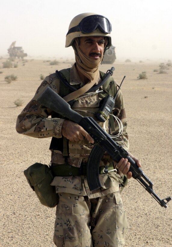 THAR THAR REGION, Iraq - An Iraqi soldier patrols through a field north of Fallujah June 21, searching for buried weapons and explosives.  The Iraqi soldiers assisted U.S. personnel during Operation Dagger, a five-day long effort to rid regions north of Fallujah of insurgent activity.