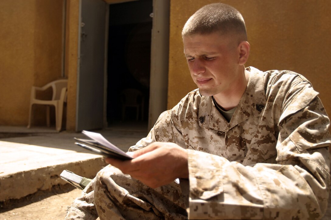 Hit, Al Anbar, Iraq (August 25, 2005)--Sgt. Keith M. Wagner, a 22-year-old Drums, Penn., native and squad leader with Company K, 3rd Battalion, 25th Marine Regiment reviews his notes after a patrol.