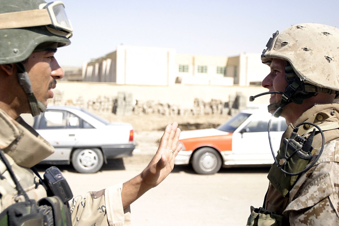 Hit, Al Anbar, Iraq (August 25, 2005)--An Iraqi soldier and Sgt. Keith M. Wagner, a 22-year-old Drums, Penn., native and squad leader with Company K, 3rd Battalion, 25th Marine Regiment talk during a patrol stop. (Official USMC Photo by Cpl. Ken Melton)