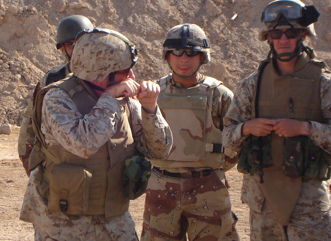 05- CAMP HABBANIYAH, Iraq - Chief Warrant Officer 5 Terry L. Walker, the 2nd Marine Division Gunner, discusses how to get into a solid firing position behind a machine gun with Iraqi soldiers attending the Iraqi Small Arms Weapons Instructor Course taught by the Marines of the 2nd Marine Division Training Center here.