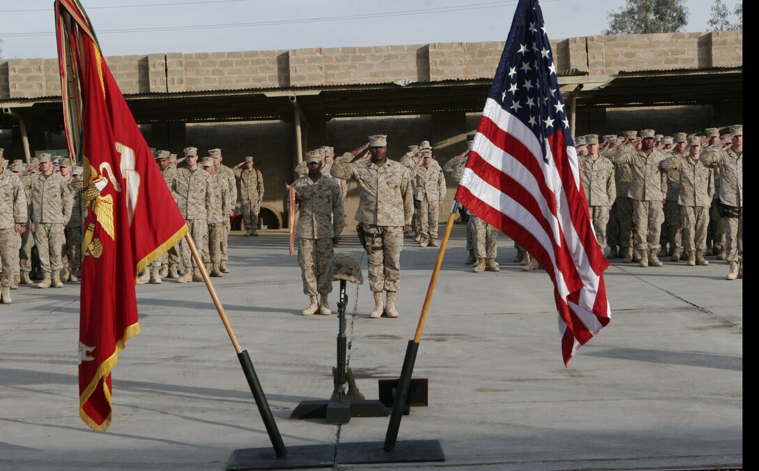 After a final roll call Dec. 21 aboard Camp Fallujah, Marines from Regimental Combat Team 8, 2nd Marine Division, render salute to a fallen Marine, Cpl. Michael B. Presley, 21, of Batesville, Miss., who died Dec. 15 of wounds sustained from a suicide, vehicle-born improvised explosive device in Fallujah.