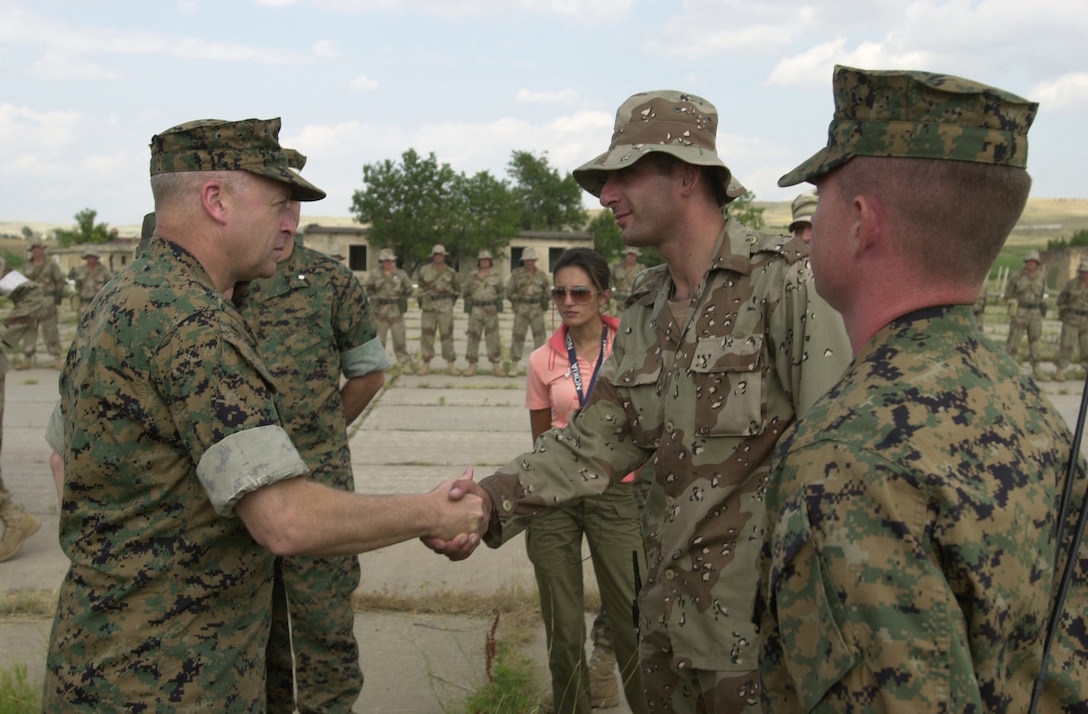 VASIANI, Georgia ? Marine Brig. Gen. John Croley, left, vice commander of U.S. Marine Corps Forces Atlantic, meets with Georgian Lt. P. Aphtsiauri, Bravo Company Commander, here July 21. Croley spoke to the company commander and his troops on the importance of the Georgia Sustainment and Stability Operations Program and training the Georgian Army for their upcoming deployment to Iraq.