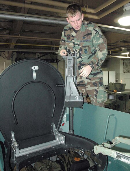 MINOT AIR FORCE BASE, N.D. -- Senior Airman Kevin McKiernan prepares to load a grenade launcher onto the Lenco Bearcat turret here Jan. 18.  The vehicle is a test vehicle that may one day replace Humvees at places like Minot.  Airman McKiernan is assigned to the 791st Missile Security Forces Squadron.  (U.S. Air Force photo by Senior Airman Katie Booher)