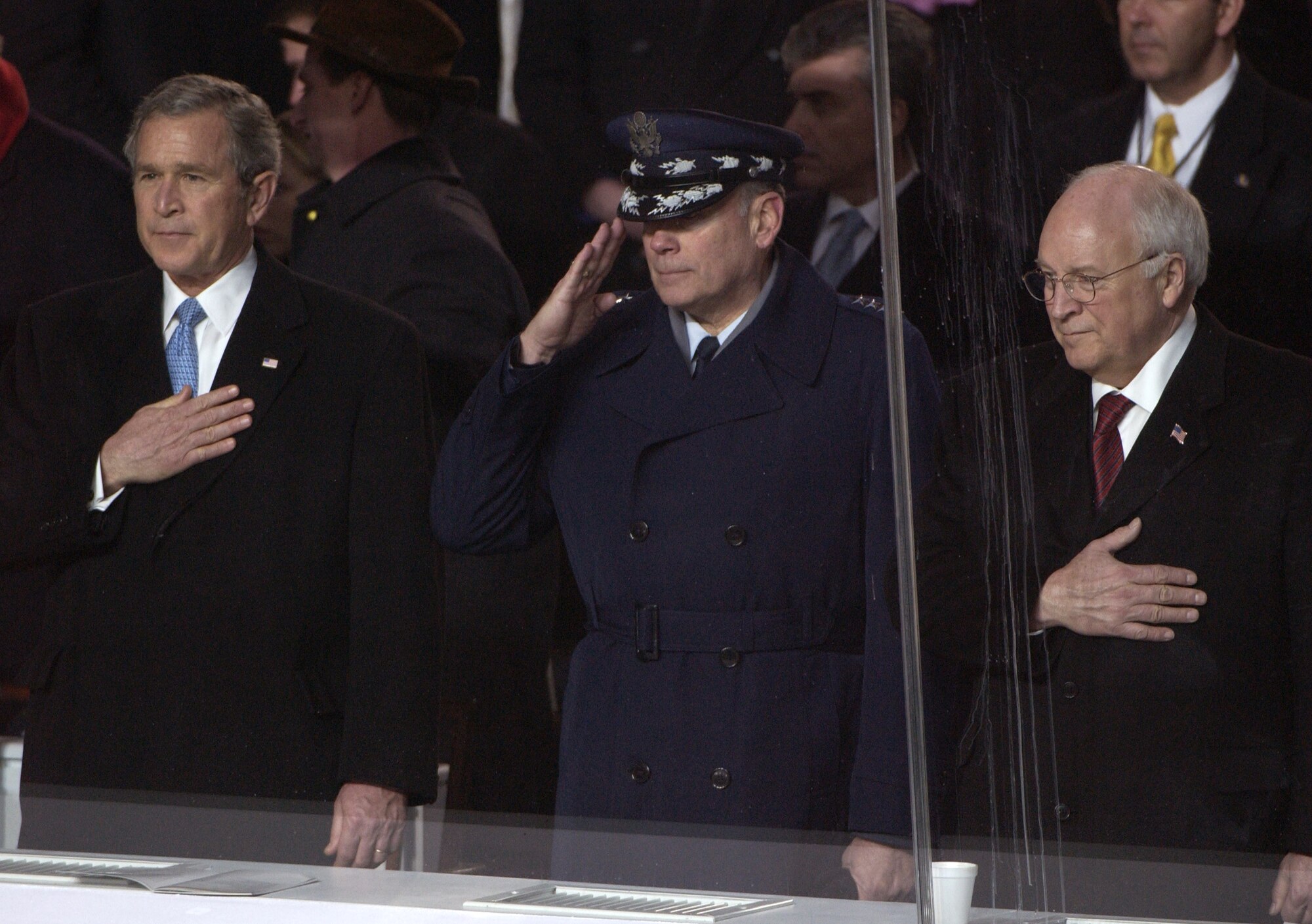 WASHINGTON -- President George W. Bush (from left), Air Force Chief of Staff Gen. John P. Jumper and Vice President Dick Cheney salute as the American flag passes during the 2005 Presidential Inaugural Parade here Jan. 20, 2005.  (U.S. Air Force photo by Tech. Sgt. Tracy DeMarco)
