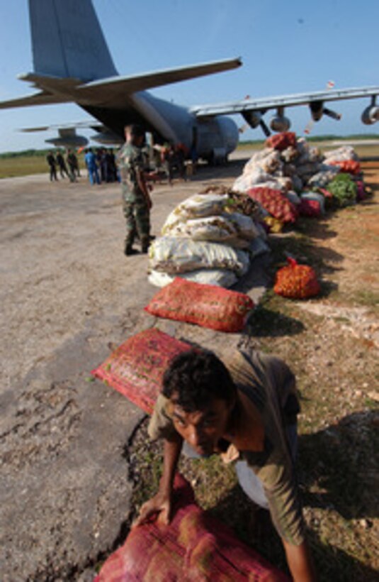 Residents of Jaffna, Sri Lanka, unload bags of vegetables from a U.S. Marine Corps C-130 Hercules on Jan. 19, 2005. More than 14,000 U.S. service members are deployed with Combined Support Force-536 supporting Operation Unified Assistance, working with international militaries and non-governmental organizations to aid those affected by the Dec. 26, 2004, Indian Ocean tsunami. The Hercules and its crew are attached to the 152nd Fixed Wing Aerial Refuel and Transport Squadron. 