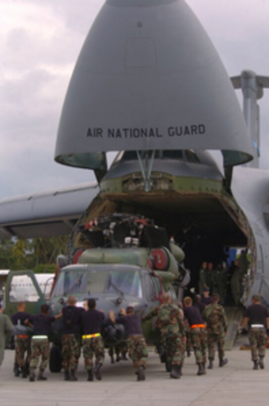 An Air Force HH-60G Pave Hawk helicopter from the 33rd Rescue Squadron, Kadena Air Base, Japan, is loaded inside a C-5 Galaxy cargo aircraft during Operation Unified Assistance at Colombo, Sri Lanka, on Jan. 20, 2005. Kadena helicopters, maintenance personnel and aircrew members are going back to their home station after helping deliver relief goods to tsunami victims in Sri Lanka. 