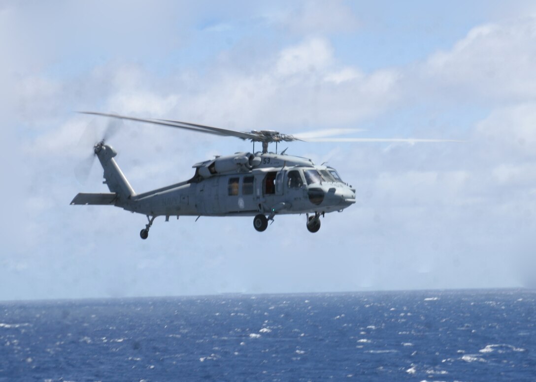 ABOARD USS PELELIU (LHA-5), (Sept. 29, 2008)- A MH-60S Seahawk helicopter maneuvers into position during a vertical replenishment, Sept. 29. Vertical replenishments are designed to resupply a Peleliu using helicopters to transport supplies from one ship to another.::r::::n::The Camp Pendleton, Calif., based 15th MEU is embarked aboard USS Peleliu and is comprised of approximately 2,200 Marines and Sailors and is a forward deployed force in readiness capable of conducting numerous operations, such as Non-Combatant Evacuation Operations, Humanitarian Assistance Operations and range of amphibious missions.  The MEU is currently deployed aboard USS Peleliu (LHA-5), USS Dubuque (LPD-8) and USS Pearl Harbor (LSD-52).   (Official USMC photo by Cpl Stephen Holt)::r::::n::
