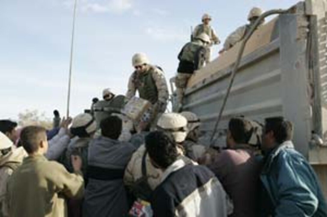 Lance Cpl. David Lewellyn, cannoneer, Charlie Battery, 1st Battalion, 11th Marines, escorts a detainee at a VCP. The unit set up roadside checkpoints designed to catch insurgents. The training is part of the 13th MEU's TRUEX 05-1.
