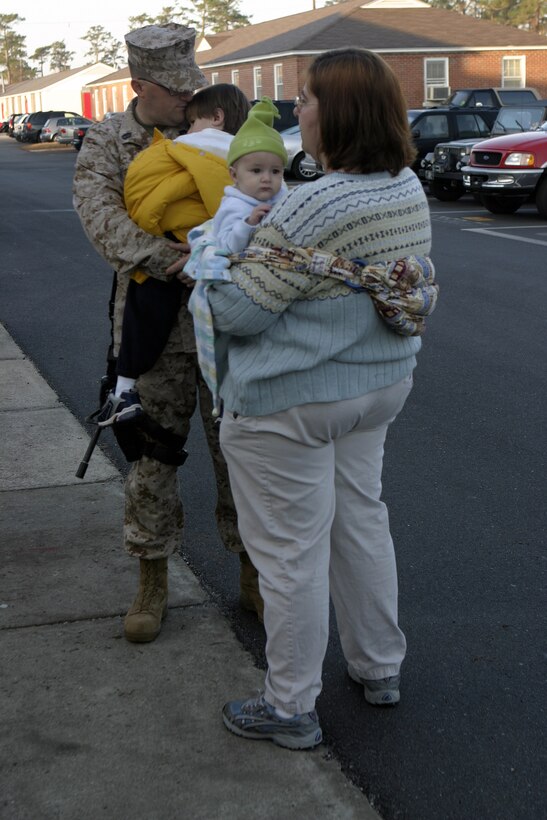 MARINE CORPS BASE CAMP LEJEUNE, N.C. - Gunnery Sgt. Francesco J. Schillaci, 1st Battalion, 6th Marine Regiment's communications maintenance chief, says his final goodbyes to loved ones before boarding a bus headed for Cherry Point Air Station, N.C.  Schillaci was one of approximately 50 Marines and sailors to leave here for Iraq as part of 1st Battalion, 6th Marine Regiment's advance party to help pave the way for the arrival of the main body in March.  Official U.S. Marine Corps photo by: