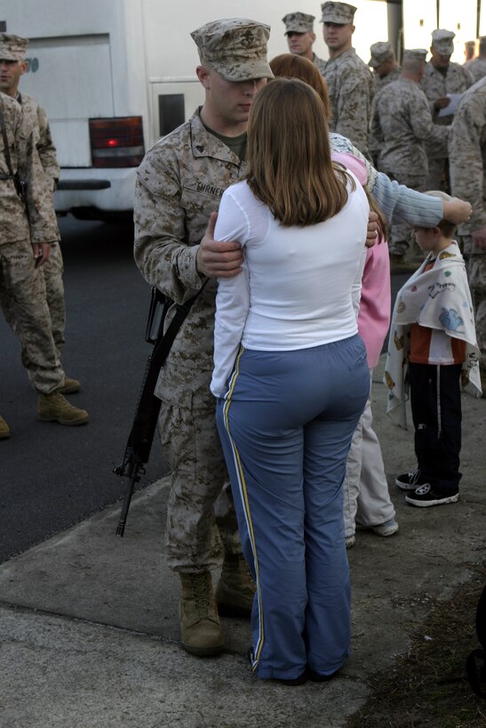 MARINE CORPS BASE CAMP LEJEUNE, N.C. - A Marine with 1st Battalion, 6th Marine Regiment says goodbye to his significant other before boarding a bus headed for Cherry Point Air Station, N.C.  Approximately 50 Marines and sailors left for Iraq as part of 1st Battalion, 6th Marine Regiment's advance party to help pave the way for the arrival of the main body in March.