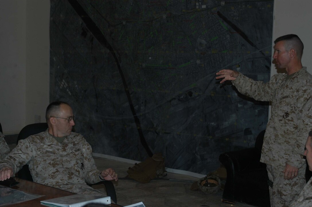 CAMP HURRICANE POINT, Ar Ramadi, Iraq(March 22, 2005) - Lieutenant. Col. Eric M. Smith, commanding officer, 1st Battalion, 5th Marine Regiment, showed Lt. Gen. Wallace C. Gregson, commanding general of U.S. Marine Forces Pacific, the infantry battalion's area of operations on a large-scale map in the Command Operations Center conference Room here. General Gregson visited HP during his tour of the areas' Marine Camps. Nine Marines and one Navy corpsman had the opportunity to meet the general and listen to him discuss the importance of their efforts in Operation Iraqi Freedom. Photo by Cpl. Tom Sloan.