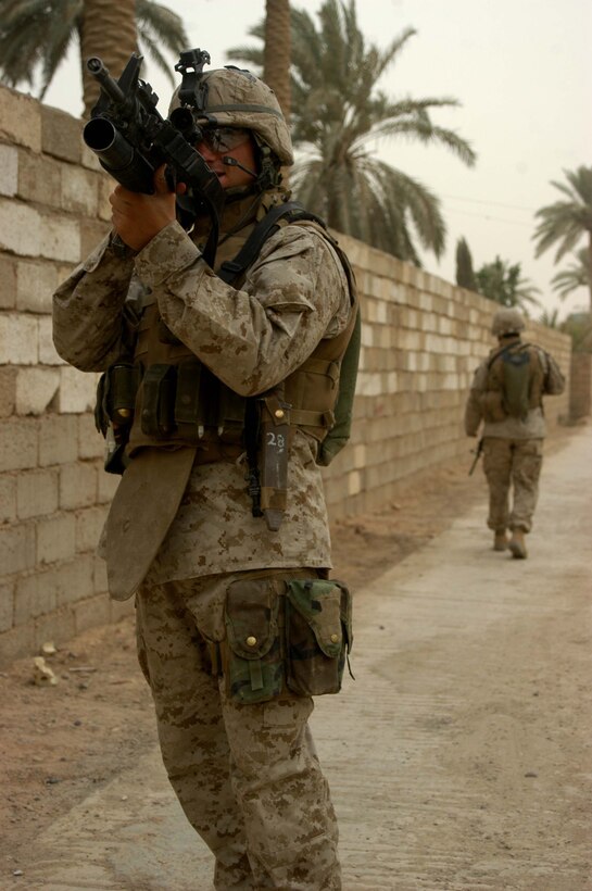 AR RAMADI Iraq (June 20, 2005) - Corporal Donald W. Ball, a team leader and machine gunner with 3rd Squad, 4th Platoon, Company B, 1st Battalion, 5th Marine Regiment, uses his scope to get a better look at a position during a patrol through the city here June 20. It was the 22-year-old Salt Lake City natives last combat mission. Ball is a three-time veteran of Operation Iraqi Freedom. He leaves Iraq in July and the Marines with an honorable discharge in September. He plans on attending the University of Utah in pursuit of a Bachelor's of Arts degree. Photo by: Cpl. Tom Sloan