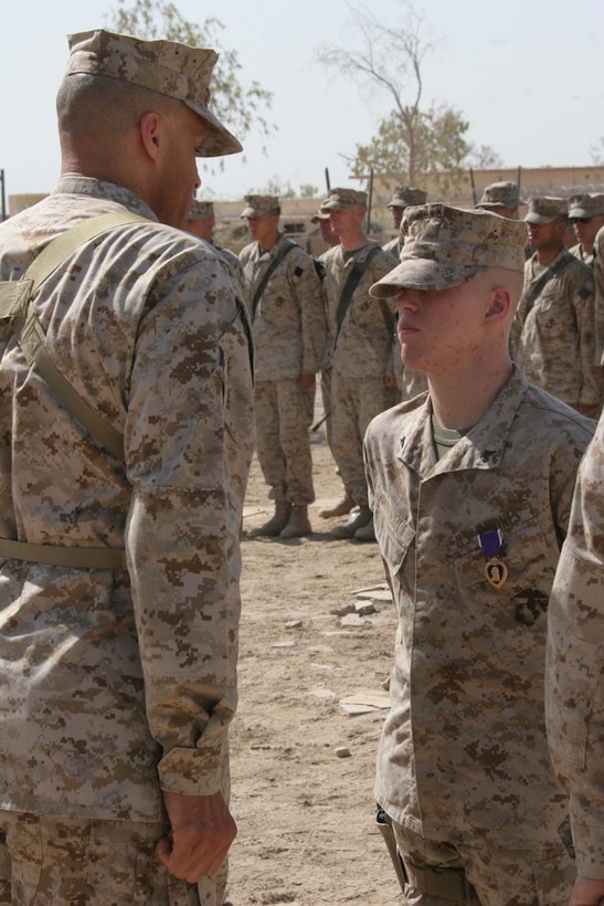 CAMP FALLUJAH, Iraq -- Lance Cpl. Tony L. Mallett, an Orange, Mass., native was awarded his Purple Heart Medal by Brig. Gen. James L. Williams, Assitant Division Commander, 2nd Marine Division.  Mallett was awarded his medal for wounds received from an Improvised Explosive Device while on a security patrol.  Official U.S. Marine Corps photo by Cpl. Athanasios L. Genos