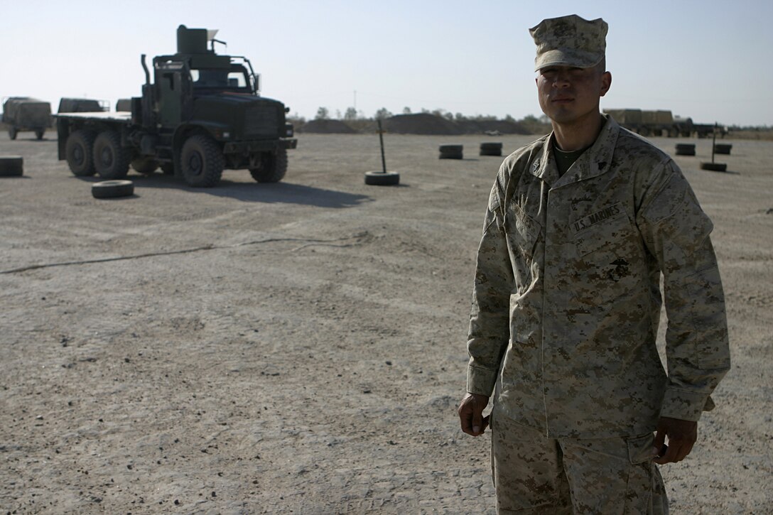 CAMP BAHARIA, Iraq - Corporal Jesus Valles works as a vehicle operator with 2nd Platoon, Truck Company, Headquarters Battalion, 3rd Marine Division.  The 25-year-old Pecos, Texas native and his fellow vehicle mechanics and operators, originally from Okinawa, have been working alongside 1st Battalion, 6th Marine Regiment personnel in and around Fallujah since mid-March, accomplishing tasks such as servicing vehicles, conducting supply and logistics convoys, and transporting the infantrymen around the city.