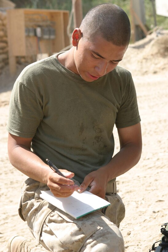 CAMP BLUE DIAMOND, RAMADI, Iraq - Lance Corporal Jorge T. Villafuerte,  a warehouseman with Headquarters Battalion, 2nd Marine Division makes annotations while inventorying a box of computer equipment here. The influx of equipment, hygiene products, uniforms, boots and other items for the hundreds of camp's inhabitants keeps him working for hours in the desert sun. Official Marine Corps photo by: Sgt. Ryan S. Scranton