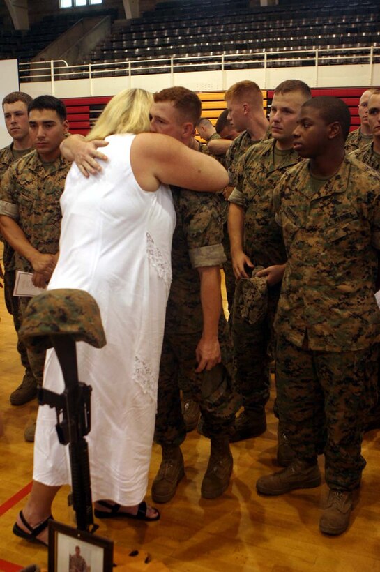 MARINE CORPS BASE CAMP LEJEUNE, N.C., -- Following the memorial ceremony honoring those Marines who gave their lives during Operation Iraqi Freedom, one of the mothers hugged all the members of her son's squad here Sept. 22.  Many tears were shed as the parents thanked their son's fellow comrades for the work they did.  Official U.S. Marine Corps photo by Cpl. Athanasios L. Genos