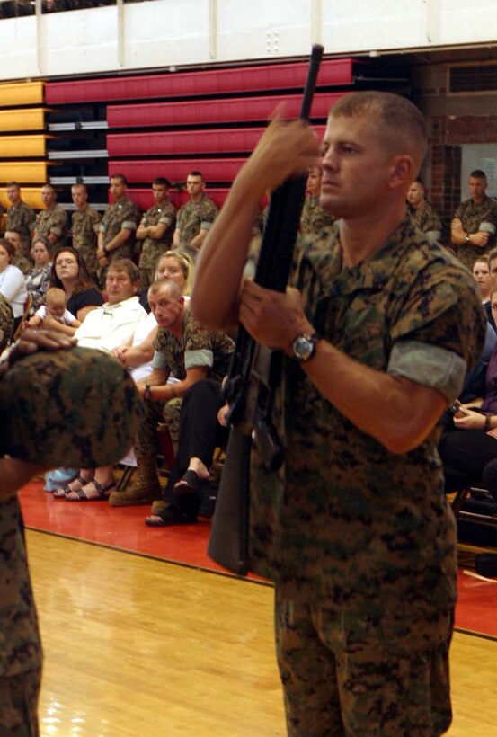 MARINE CORPS BASE CAMP LEJEUNE, N.C., -- Staff Sgt. Thomas Hill, a platoon sergeant with Company I placed the rifle in position for the display of deceased Company Gunnery Sgt. Terry Ball.  Each display was presented by three Marines from each company the Marine was from.  Official U.S. Marine Corps photo by Cpl. Athanasios L. Genos