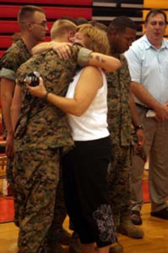 MARINE CORPS BASE CAMP LEJEUNE, N.C., -- Following the memorial ceremony honoring those Marines who gave their lives during Operation Iraqi Freedom, one of the mothers hugged all the members of her son's squad here Sept. 22.  Many tears were shed as the parents thanked their son's fellow comrades for the work they did.