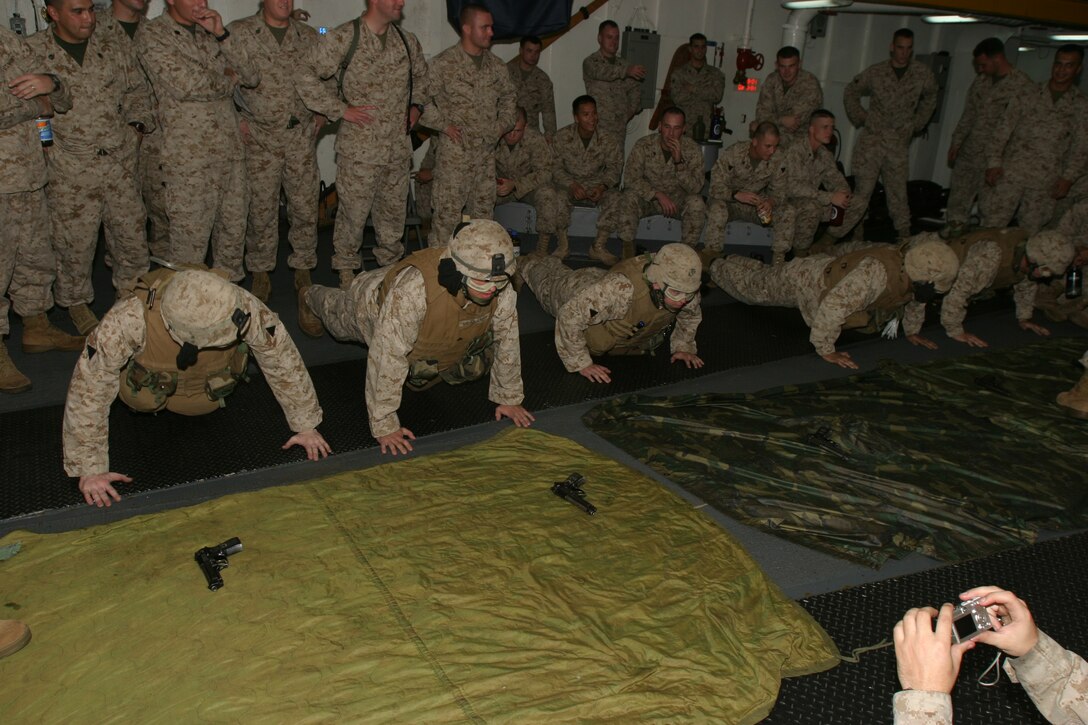Marines of Charlie Company, Battalion Landing Team 1/1, 15th Marine Expeditionary Unit (Special Operations Capable), participate in a competition to assemble and disassemble various small arms weapons.